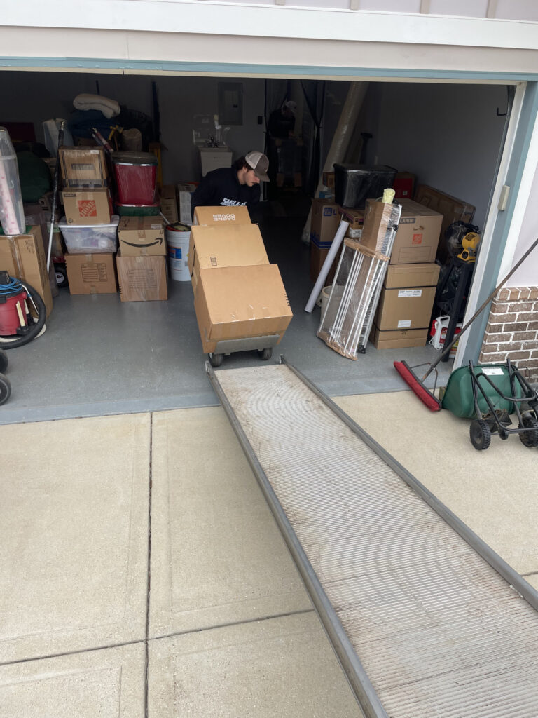 Moving crew carrying boxes into a house